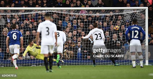 Everton's Dutch goalkeeper Maarten Stekelenburg looks to the ball as Swansea City's Icelandic midfielder Gylfi Sigurdsson scores his team's first...