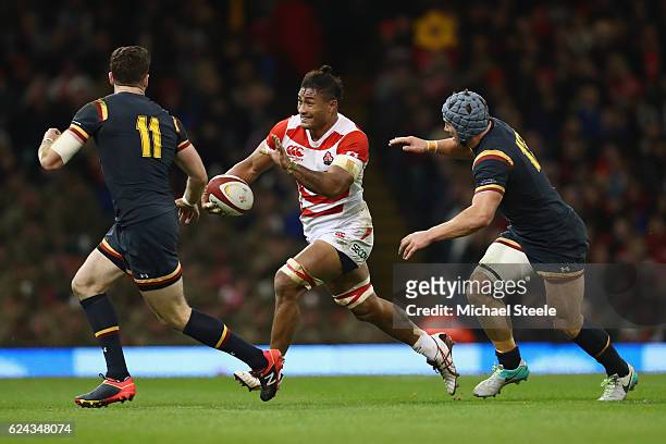 Amanaki Lelei Mafi of Japan cuts between Jonathan Davies and Alex Cuthbert of Wales during the International match between Wales and Japan at the...