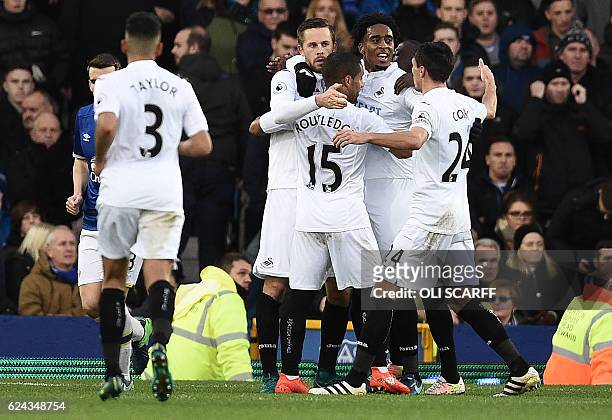 Swansea City's Icelandic midfielder Gylfi Sigurdsson celebrates scoring his team's first goal from the penalty spot during the English Premier League...