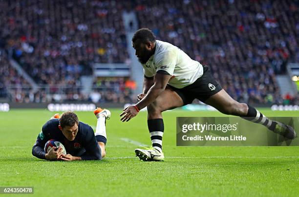 Alex Goode of England dives to score his team's sixth try during the Old Mutual Wealth series match between England and Fiji at Twickenham Stadium on...