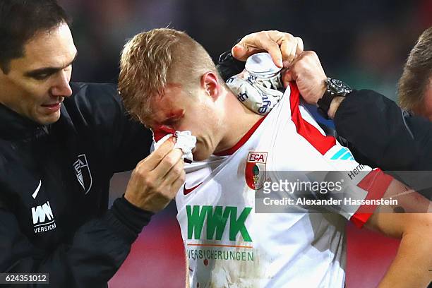 Martin Hinteregger of Augsburg leaves the field after geting injured during the Bundesliga match between FC Augsburg and Hertha BSC at WWK Arena on...