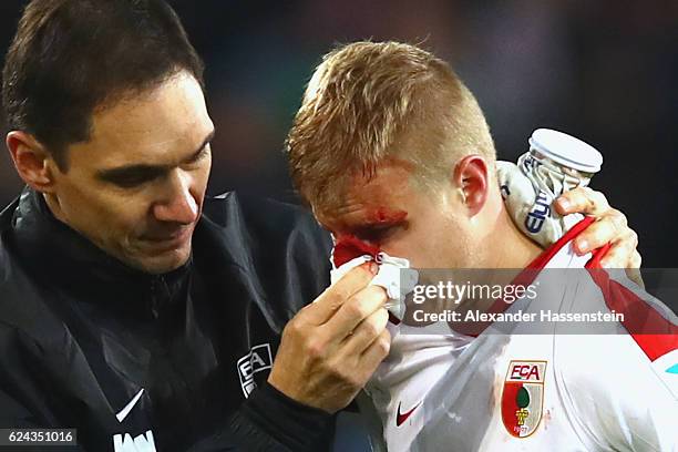 Martin Hinteregger of Augsburg leaves the field after geting injured during the Bundesliga match between FC Augsburg and Hertha BSC at WWK Arena on...