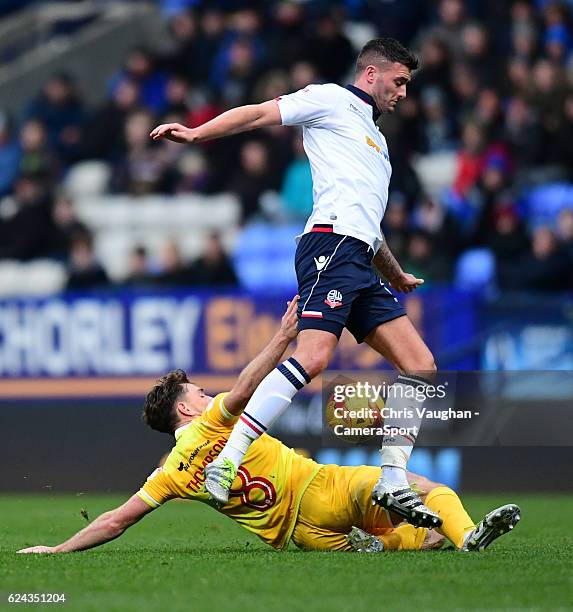 Bolton Wanderers' Gary Madine is tackled by Millwall's Ben Thompson during the Sky Bet League One match between Bolton Wanderers and Millwall at...