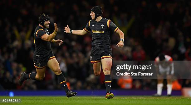 Wales player Sam Davies celebrates with Leigh Halfpenny after kicking the winning drop goal during the International match between Wales and Japan at...