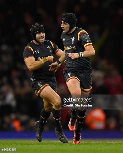 Wales player Sam Davies celebrates with Leigh Halfpenny after kicking the winning drop goal during the International match between Wales and Japan at...