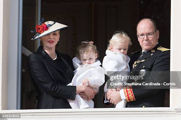 Princess Charlene of Monaco and Prince Albert II of Monaco greet the crowd from the palace's balcony with their children Princess Gabriella of Monaco...
