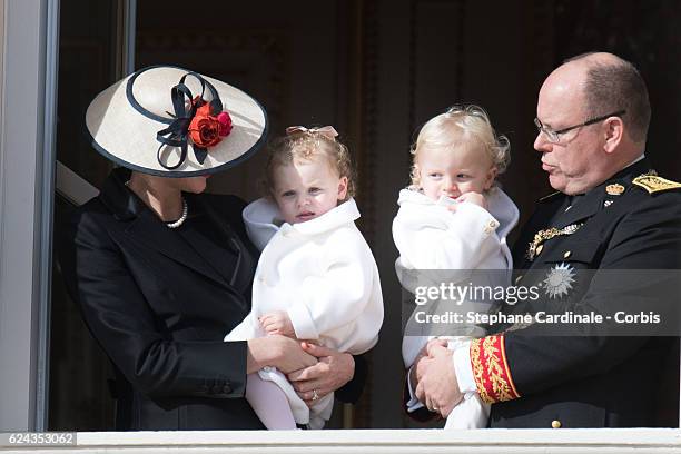 Princess Charlene of Monaco and Prince Albert II of Monaco greet the crowd from the palace's balcony with their children Princess Gabriella of Monaco...