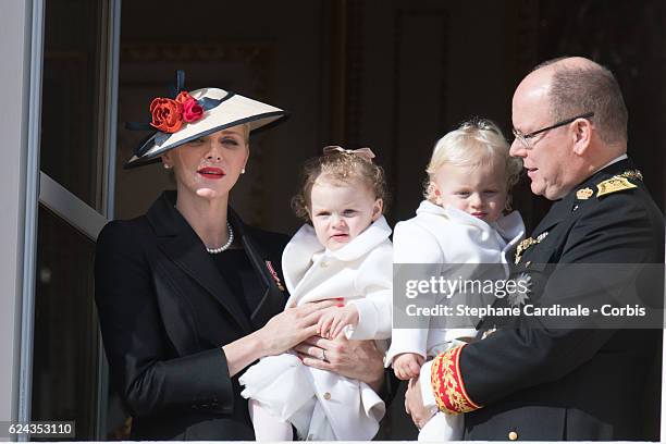 Princess Charlene of Monaco and Prince Albert II of Monaco greet the crowd from the palace's balcony with their children Princess Gabriella of Monaco...