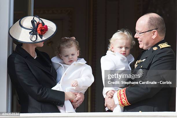 Princess Charlene of Monaco and Prince Albert II of Monaco greet the crowd from the palace's balcony with their children Princess Gabriella of Monaco...