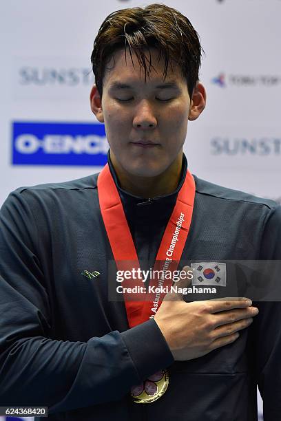 Park Taehwan of South Korea stands for his national anthem after the Men's 1500m Freestyle final during the 10th Asian Swimming Championships 2016 at...