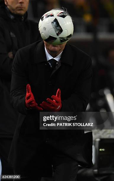 Bayern Munich's Italian head coach Carlo Ancelotti catches the ball during the German first division Bundesliga football match between Borussia...
