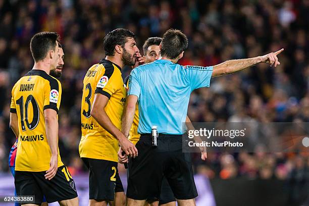 The referee shows the red card to Juankar during the match between FC Barcelona vs Malaga CF, for the round 12 of the Liga Santander, played at Camp...