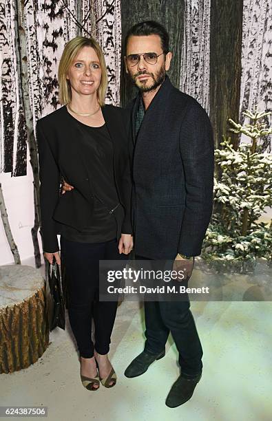 Carlo Brandelli and Charlotte Brandelli attend Claridge's Christmas Tree 2016 Party, with tree designed by Sir Jony Ive and Marc Newson, at...