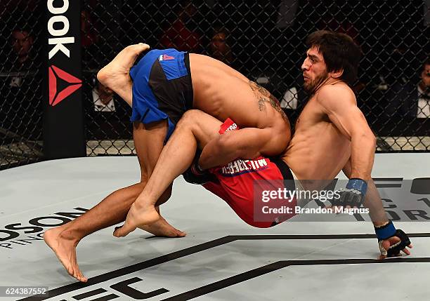 Kevin Lee takes down Magomed Mustafaev of Russia in their lightweight bout during the UFC Fight Night at the SSE Arena on November 19, 2016 in...