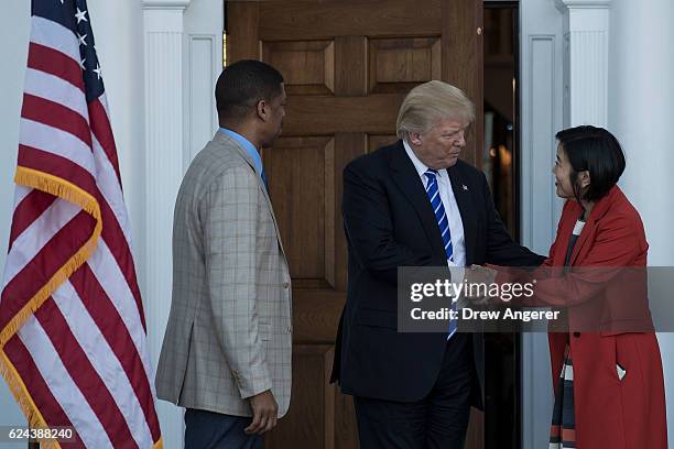 President-elect Donald Trump emerges from the clubhouse with Kevin Johnson and Michelle Rhee after their meeting at Trump International Golf Club,...