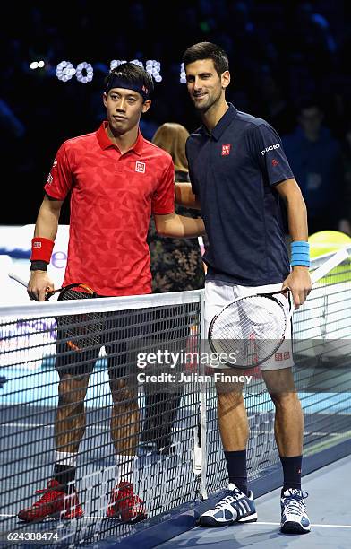 Novak Djokovic of Serbia and Kei Nishikori of Japan line up before their men's singles semi final on day seven of the ATP World Tour Finals at O2...