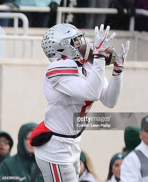 Gareon Conley of the Ohio State Buckeyes intercepts the pass from Tyler O'Connor of the Michigan State Spartans during the fourth quarter at Spartan...
