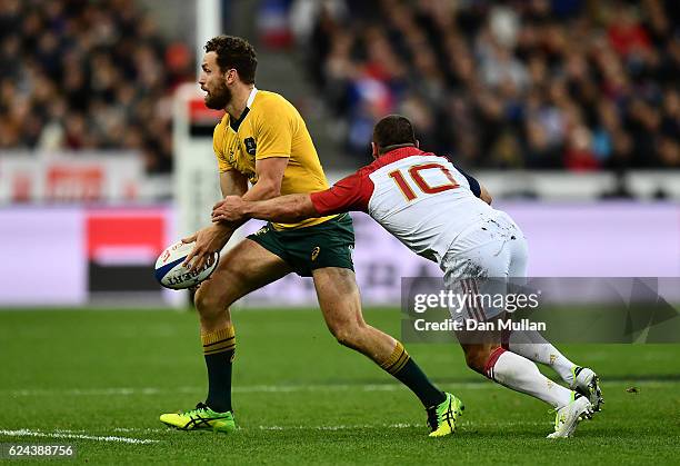 Luke Morahan of Australia is tackled by Jean Marc Doussain of France during the international match between France and Australia at Stade de France...