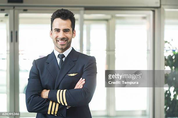 aeroplane pilot looking at camera and smiling. - een vliegtuig besturen stockfoto's en -beelden