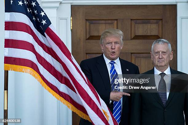 President-elect Donald Trump welcomes retired United States Marine Corps general James Mattis as they pose for a photo before their meeting at Trump...