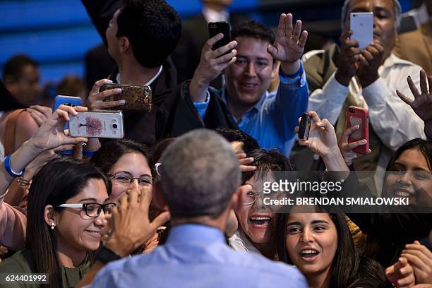 President Barack Obama greets people after speaking at a Young Leaders of the Americas Initiative town hall meeting at the Pontifical Catholic...