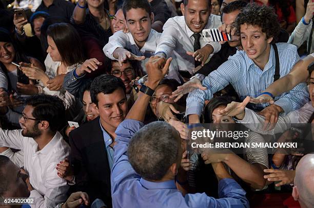 President Barack Obama greets people after speaking at a Young Leaders of the Americas Initiative town hall meeting at the Pontifical Catholic...