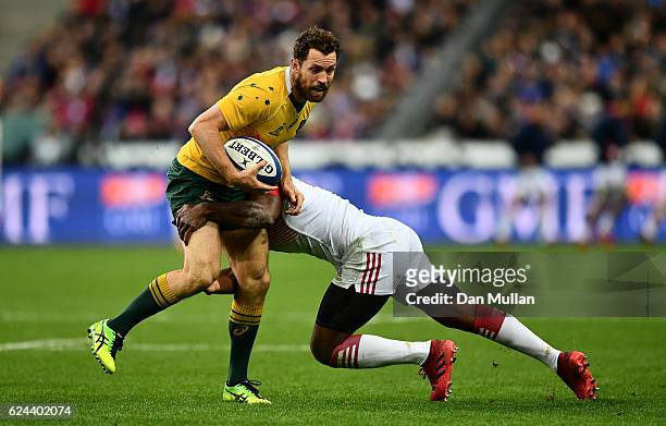 Luke Morahan of Australia is tackled by Noa Nakaitaci of France during the international match between France and Australia at Stade de France on...