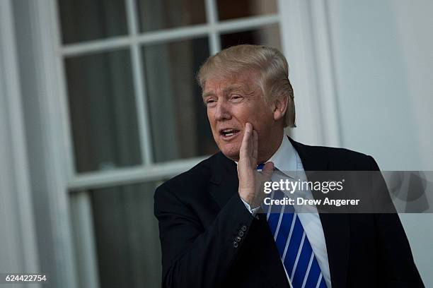 President-elect Donald Trump jokes with the press before his meeting with Bob Woodson, president of the Center for Neighborhood Enterprise, at Trump...