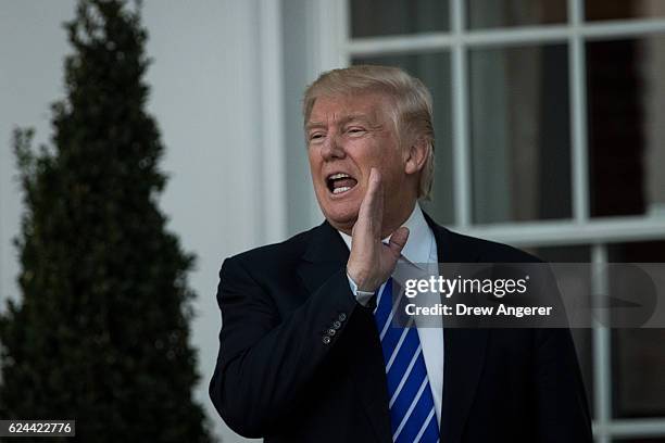 President-elect Donald Trump jokes with the press before his meeting with Bob Woodson, president of the Center for Neighborhood Enterprise, at Trump...