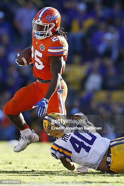 Jordan Scarlett of the Florida Gators is tackled by Duke Riley of the LSU Tigers during the second half of a game at Tiger Stadium on November 19,...
