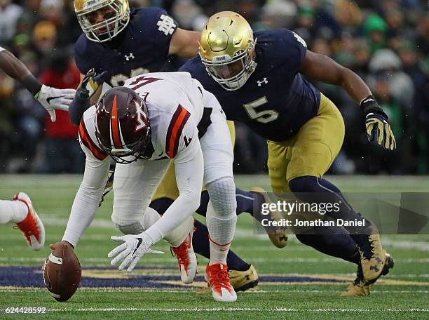 Jerod Evans of the Virginia Tech Hokies moves to recover a teammates fumble in front of Nyles Morgan of the Notre Dame Fighting Irish at Notre Dame...