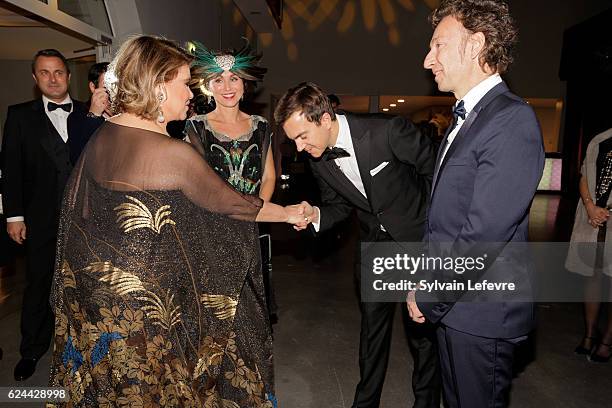 Luxembourg Prime Minister Xavier Bettel, Grand Duchess Maria Teresa of Luxembourg who greets Stephane Aubert, Artcurial auctioneer, as she attends...