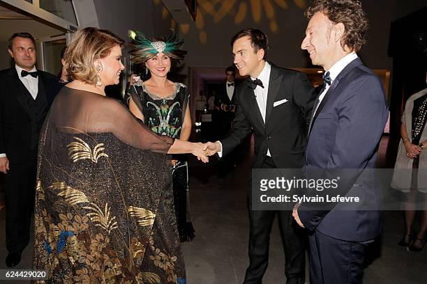 Luxembourg Prime Minister Xavier Bettel, Grand Duchess Maria Teresa of Luxembourg who greets Stephane Aubert, Artcurial auctioneer, as she attends...