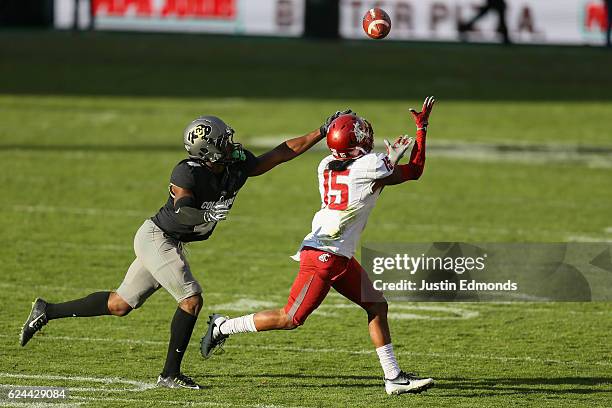 Wide receiver Robert Lewis of the Washington State Cougars makes a catch while being defended by defensive back Chidobe Awuzie of the Colorado...