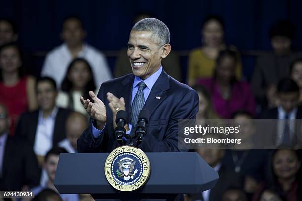 President Barack Obama claps while speaking during a town hall meeting at the Pontifical Catholic University in Lima, Peru, on Saturday, Nov. 19,...