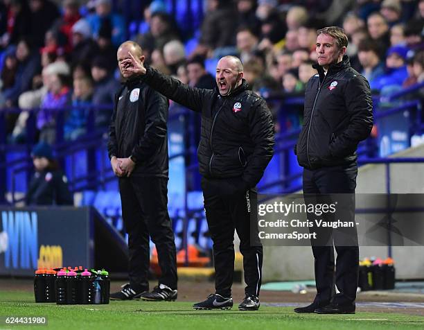 Bolton Wanderers's assistant manager Steve Parkin, left, and Bolton Wanderers manager Phil Parkinson shouts instructions to their team from the...