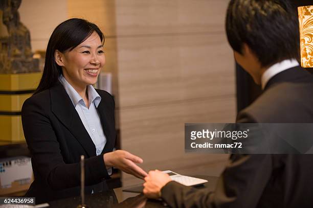asian concierge in hotel with customer - concierge hotel stock pictures, royalty-free photos & images