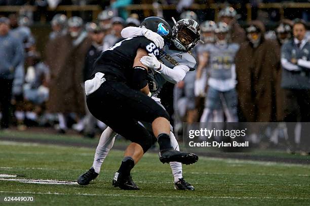 Darius Phillips of the Western Michigan Broncos tackles Mason Schreck of the Buffalo Bulls in the second quarter at Waldo Stadium on November 19,...