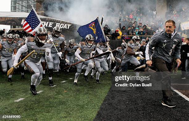 Head coach P.J. Fleck of the Western Michigan Broncos leads his team onto the field before the game against the Buffalo Bulls at Waldo Stadium on...