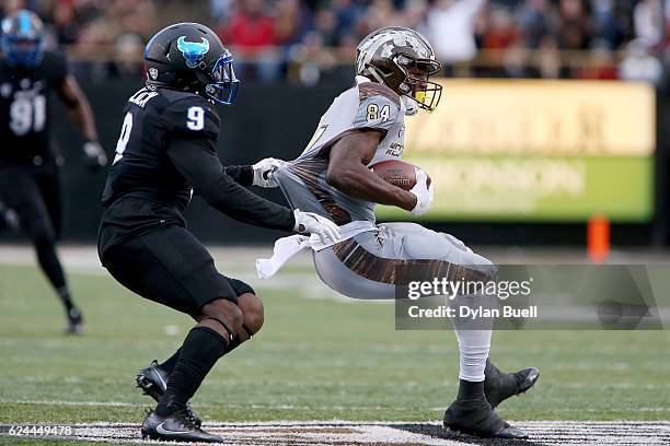 Tatum Slack of the Buffalo Bulls attempts to bring down Corey Davis of the Western Michigan Broncos in the second quarter at Waldo Stadium on...