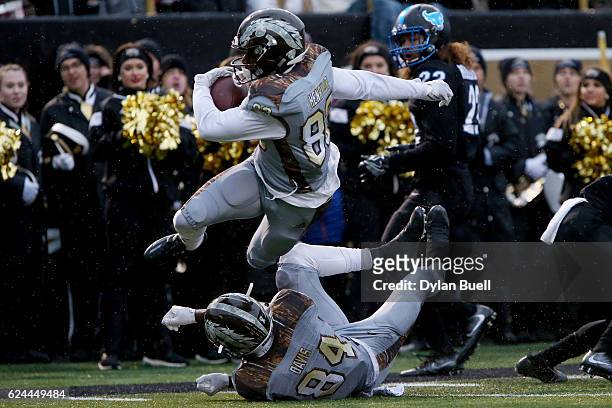 Michael Henry of the Western Michigan Broncos is tripped up by teammate Corey Davis in the second quarter against the Buffalo Bulls at Waldo Stadium...