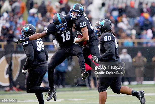 Ishmael Hargrove and Ryan Williamson of the Buffalo Bulls celebrate after recovering a fumble in the second quarter against the Western Michigan...