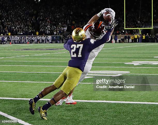 Bucky Hodges of the Virginia Tech Hokies catches a tpouchdown pass in front of Julian Love of the Notre Dame Fighting Irish at Notre Dame Stadium on...