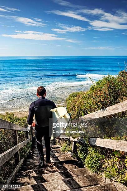 surfing at bells beach near torquay, victoria, australia, south pacific - bells beach stock-fotos und bilder
