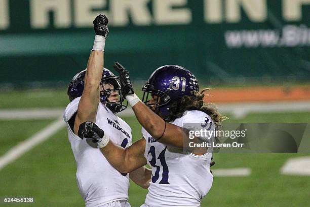 Wide receiver Drew Batchelor and running back Haini Moimoi of the Weber State Wildcats celebrate after a touchdown during second half action on...