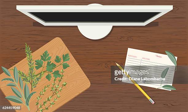 cooking background with herbs on a table with computer - wood desk stock illustrations
