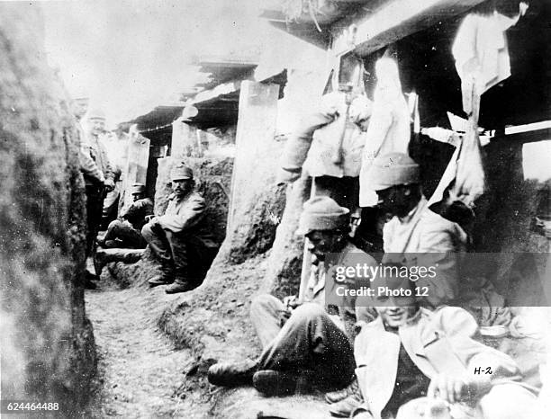 _German soldiers relaxing in their trench during a lull in fighting.