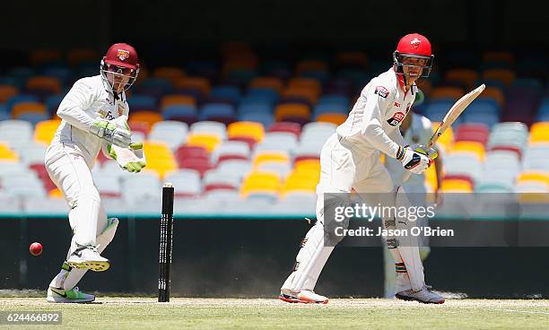 Alex Carey of the Redbacks hits a shot past Chris Hartley during day four of the Sheffield Shield match between Queensland and South Australia at The...