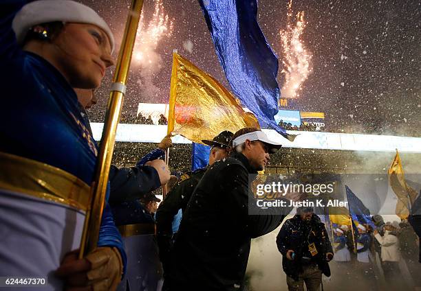 Dana Holgorsen of the West Virginia Mountaineers enters the field against the Oklahoma Sooners on November 19, 2016 at Mountaineer Field in...