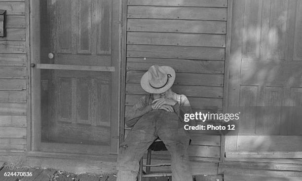Ex-farmer resting by a house in Circleville, Ohio's 'Hooverville'. 1938.
